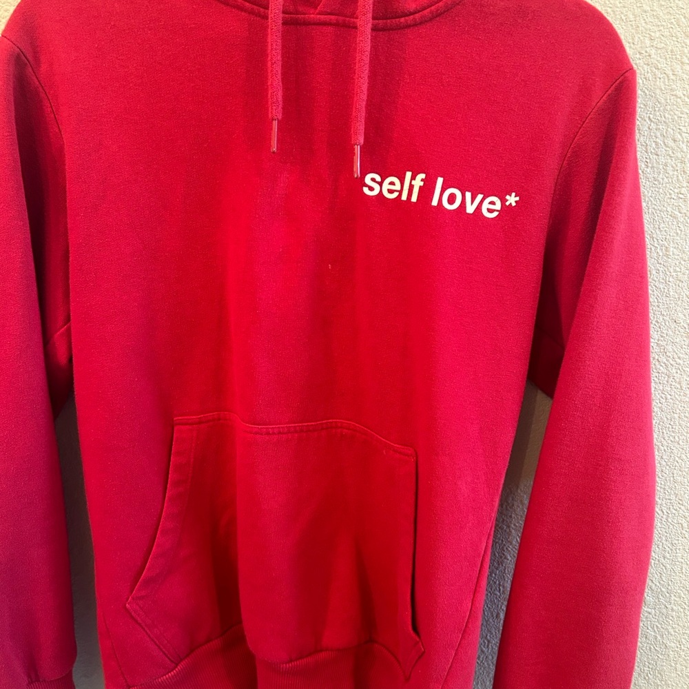 Women’s Celio Self Love red hoodie.